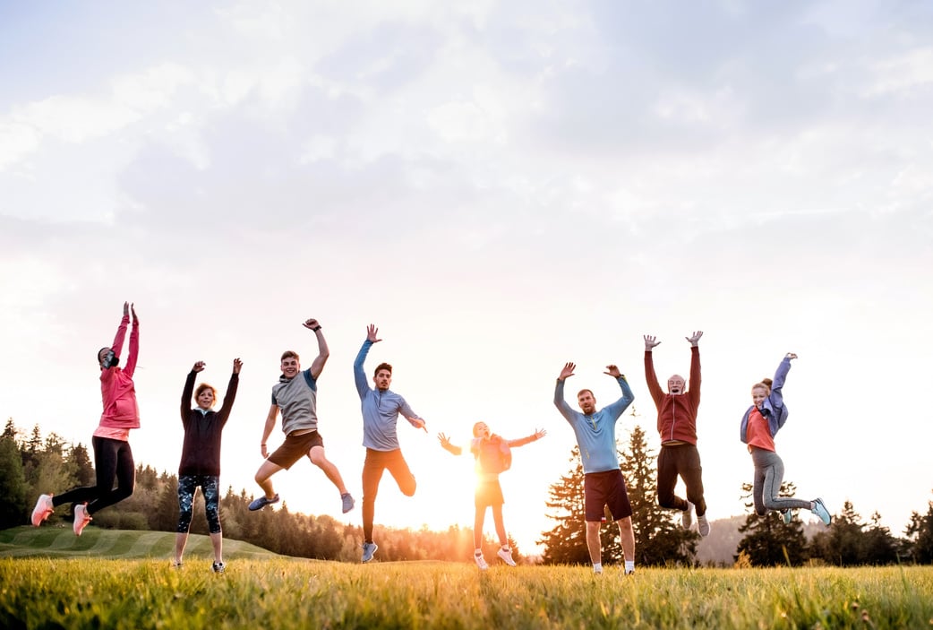 Large Group of Fit and Active People Jumping after Doing Exercise in Nature.