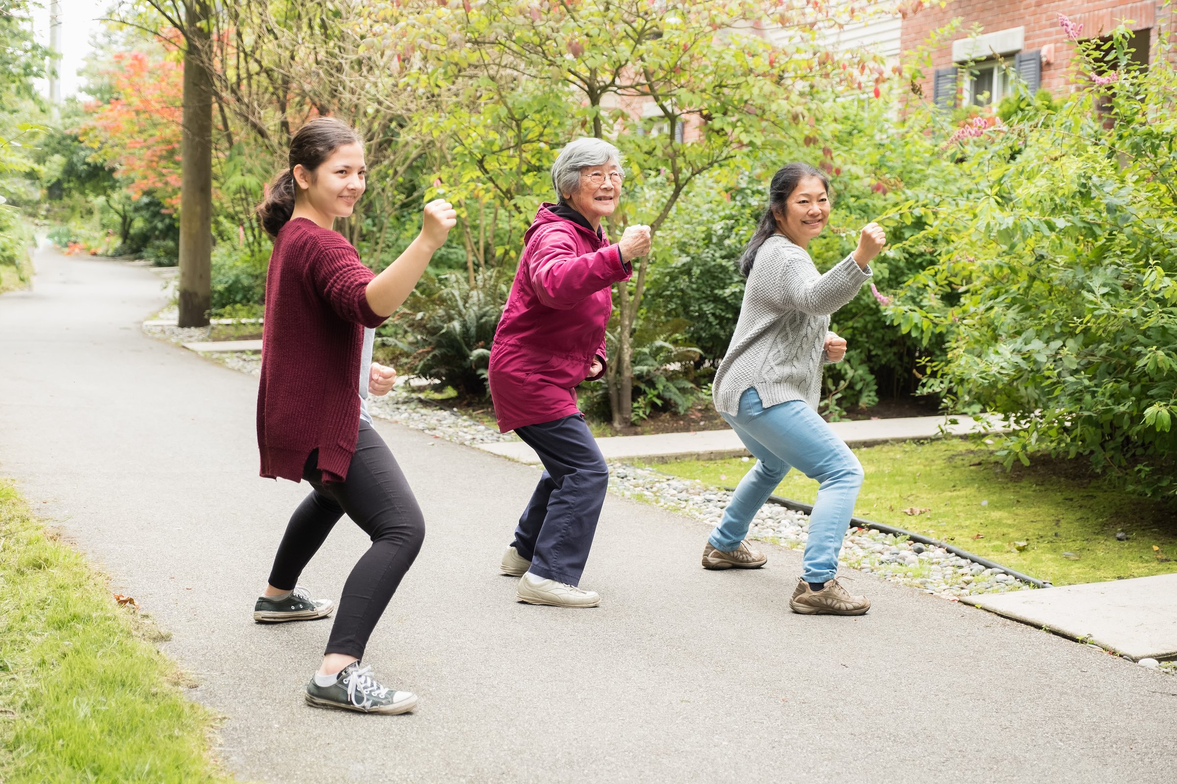 Senior Asian Woman Practicing Self Defense with Daughter and Granddaughter